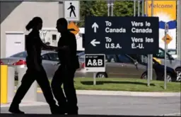  ?? DARRYL DYCK, THE CANADIAN PRESS ?? Canadian border guards are silhouette­d at an inspection booth at the Douglas border crossing on the Canada-USA border in Surrey, B.C., on Thursday.