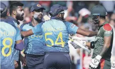  ?? AP ?? Bangladesh’s Liton Das, right, gestures threatenin­gly to Lahiru Kumara, left, with others trying to mediate in Sharjah