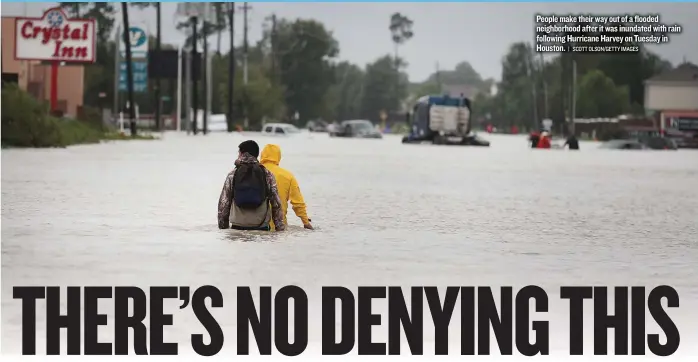  ?? | SCOTT OLSON/ GETTY IMAGES ?? People make their way out of a flooded neighborho­od after it was inundated with rain following Hurricane Harvey on Tuesday in Houston.