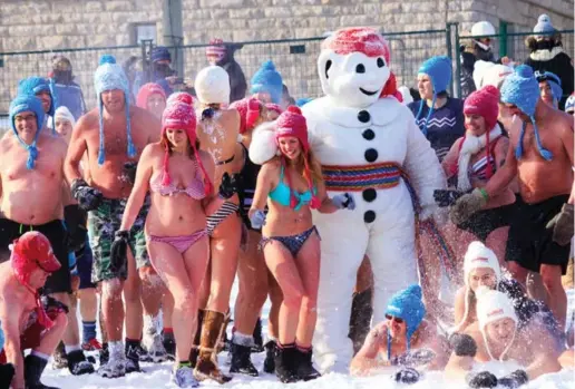  ?? MARIE-PIER AUBIN/CARNAVAL DE QUÉBEC ?? The snow bath is a chance to frolic in the snow in a bathing suit and to dance with Bonhomme at the Carnaval de Québec, or Quebec Winter Carnival.