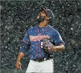  ?? GENE J. PUSKAR — THE ASSOCIATED PRESS ?? Minnesota Twins relief pitcher Fernando Rodney stands on the mound during a snow squall in the ninth inning of the team’s baseball game against the Pittsburgh Pirates in Pittsburgh, Wednesday. The Twins won 7-3.