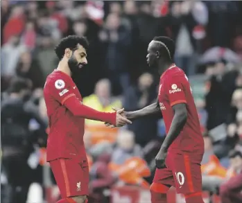  ?? AP PHOTO/JON SUPER ?? Liverpool’s Mohamed Salah (left) leaves the field as his teammate Sadio Mane enters during the English Premier League soccer match between Liverpool and Watford at Anfield stadium in Liverpool, England, on Saturday.