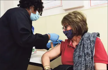  ?? Erik Trautmann / Hearst Connecticu­t Media ?? Manette Destin administer­s the coronaviru­s vaccine to Joanne Rondello as Norwalk residents take advantage of the vaccinatio­n clinic at Norwalk Community Health Center on Tuesday.