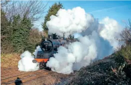  ?? PETER FOSTER ?? Steam shroud: Visiting BR Standard 4MT 2-6-4T No. 80080 appears from beneath Beeches Road bridge following its departure from Loughborou­gh on January 30.