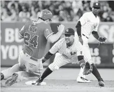  ?? Frank Franklin II Associated Press ?? THE ANGELS’ C.J. Cron attempts to steal second base as Yankees second baseman Starlin Castro fields the throw.