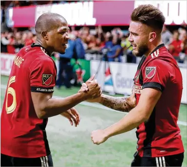  ?? CURTIS COMPTON / CCOMPTON@AJC.COM ?? Atlanta United midfielder Darlington Nagbe (left) gives Hector Villalba five after his goal during a match against the New York Red Bulls in the Eastern Conference finals on Nov. 25 in Atlanta. United won, 3-0.