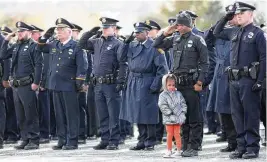  ?? LISA POWELL / STAFF FILE ?? Darnell Pate, then a Union City patrol officer, brought his daughter, Bra’Lynn Pate to the funeral services for Dayton police Detective Jorge DelRio in 2019.