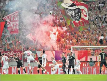  ?? GETTY ?? ■ FC Cologne fans light a flare during the club’s first home game of 2019-20 Bundesliga season, against Borussia Dortmund in August.