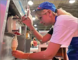  ?? DAVID ALLEN — STAFF ?? Kenzie Castaneda, 26, makes a cone at MacPherson’s Ice Cream at the L.A. County Fair. Castaneda’s mother, Nora, has been with the stand for 35years, and Kenzie’s five older sisters have worked there, too.