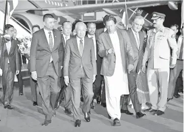  ??  ?? Dr Mahathir (fourth right) being welcomed by Imran Khan (third right) at the Pakistan Air Force Nur Khan airbase during his official three-day visit to Pakistan. - Bernama photo