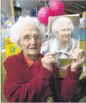  ?? Pictures: Chris Davey FM4745307/FM4745302 ?? 100-year-old Connie Brooks with staff and her son, Ben, second left at Ashworths Chemist and with her card from the Queen