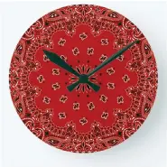  ?? ZAZZLE VIA AP ?? A wall clock that features a bandana print is shown. Zazzle has melamine plates, ceramic mugs, and ceiling and table lamps featuring the bandana paisley motif, in vibrant hues of red, blue, purple, turquoise, green or gold.