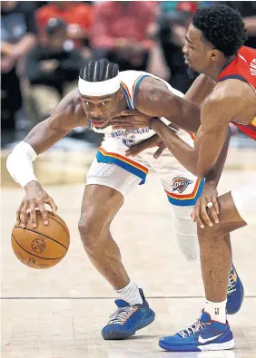  ?? SEAN GARDNER GETTY IMAGES ?? Oklahoma City’s Shai Gilgeous-Alexander, who had 24 points, drives against Herbert Jones of the Pelicans during second-quarter action on Saturday in New Orleans.