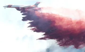  ??  ?? A plane drops fire-retardant chemicals on the 416 Fire near Durango, California. – Reuter photo