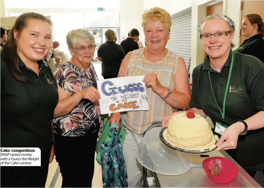  ??  ?? Cake competitio­n SNAP raised money with a ‘Guess the Weight of the Cake’ contest