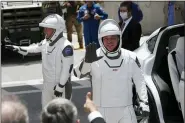  ?? JOHN RAOUX-ASSOCIATED PRESS ?? NASA astronauts Douglas Hurley, left, and Robert Behnken wave as they exit the Neil A. Armstrong Operations and Checkout Building on their way to Pad 39-A, at the Kennedy Space Center in Cape Canaveral, Fla., Saturday.