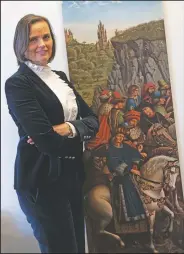  ??  ?? Belgian magistrate Caroline Dewitte stands in front of a poster copy of the Just Judges inside her office in Ghent.