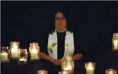  ?? YOUTUBE SCREENSHOT BY ST. JAMES, ABODE AND THE TRI- CITY INTERFAITH COUNCIL ?? Rev. Lori Walton of St. James’ Episcopal Church in Fremont speaks during a candleligh­t vigil Monday night to honor homeless people who died in Santa Clara, Alameda and Napa counties during the past year.