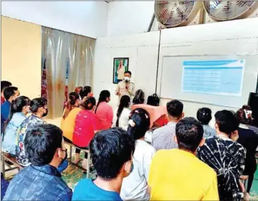  ?? LABOUR MINISTRY ?? Labour ministry officials doing outreach work on the benefits of pensions for the private sector in August.