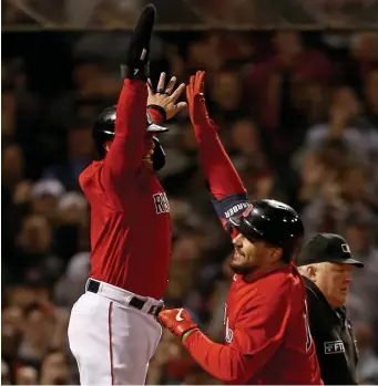  ?? MaTT sTOne pHOTOs / Herald sTaff ?? OCTOBER MAGIC: Kyle Schwarber, right, celebrates his second inning grand slam with Christian Vazquez after crossing the plate. Below, manager Alex Cora, left, gives J.D. Martinez a pat on the back after the designated hitter’s two-run bomb in the sixth inning.