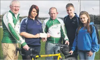  ??  ?? RIGHT: Members of the Killarney No Name Club presenting a cheque to Killarney cyclists, James Looney and Brendan Coffey, in aid of IHCPT ahead of their cycle to Lourdes.