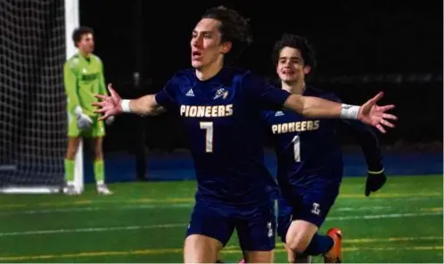  ?? BARRY CHIN/GLOBE STAFF ?? Lynnfield’s Dillon Reilly celebrates after scoring the winner against Monomoy in the Division 4 soccer final.