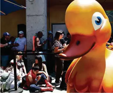  ?? NYT PIC ?? Fans line up to get into the inner courtyard of the DC immersive experience at Comic-Con Internatio­nal in San Diego, California, on Thursday. Publishers, like DC and Dark Horse Comics, are creating their own digital platforms to connect more directly...