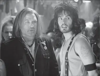  ?? By David James, Warner Bros. Pictures ?? Lip locked: Alec Baldwin, left, and Russell Brand share a smooch in the upcoming rock musical Rock of Ages. “When I kissed Russell, I had to stop myself from crying, actually. Because I was so in love with him,” Baldwin says.