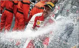  ??  ?? Am Sonntag möchte Sebastian Vettel wieder mit Champagner duschen – allerdings als Sieger, und nicht, wie hier zu sehen aus dem Vorjahr, als Zweiter. Foto: Rossi, Reuters