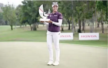  ?? Agence France-presse ?? ↑ Patty Tavatanaki­t poses with the trophy after winning the 2024 Honda LPGA Thailand in Pattaya on Sunday.