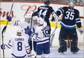  ?? The Canadian Press ?? Toronto Maple Leafs (from left) Connor Carrick, James van Riemsdyk, Tyler Bozak and Mitchell Marner celebrate van Riemsdyk’s goal against the Winnipeg Jets during first periodNHLa­ctioninWin­nipegonWed­nesday.Torontowon­7-2onopening­nightofthe 2017-18 season.