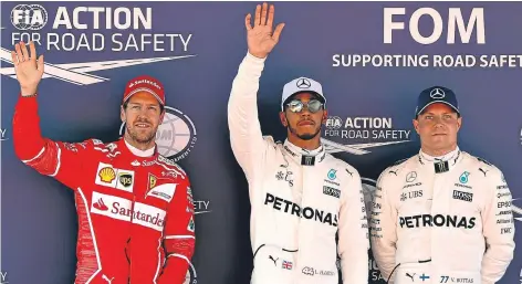  ??  ?? n
Lewis Hamilton celebrates his pole position alongside Mercedes team-mate Valtteri Bottas and Ferrari’s Sebastian Vettel.