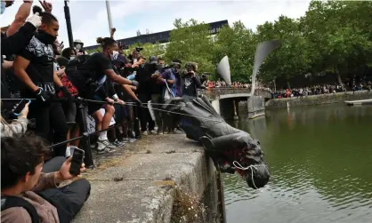  ?? Photograph: Ben Birchall/PA ?? ‘The Colston statue topplers are the ones trying to drag Britain’s view of itself closer to reality.’ Protesters throw a statue of Edward Colston into Bristol harbour in June 2020.