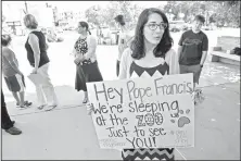  ?? The Record ?? Melissa Peters holds a sign she plans to display in Philadelph­ia during Pope Francis’ visit. She and others parishione­rs of Our Lady of Mount Carmel Church in Ridgewood, N.J., plan to sleep among exhibits at the Philadelph­ia Zoo as an alternativ­e to...