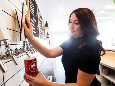  ?? MATT SMITH ?? Madeline Conn of High Key Brewery pours a pint of their Jolly Roger red ale, her recommenda­tion for a St. Patrick’s Day brew.