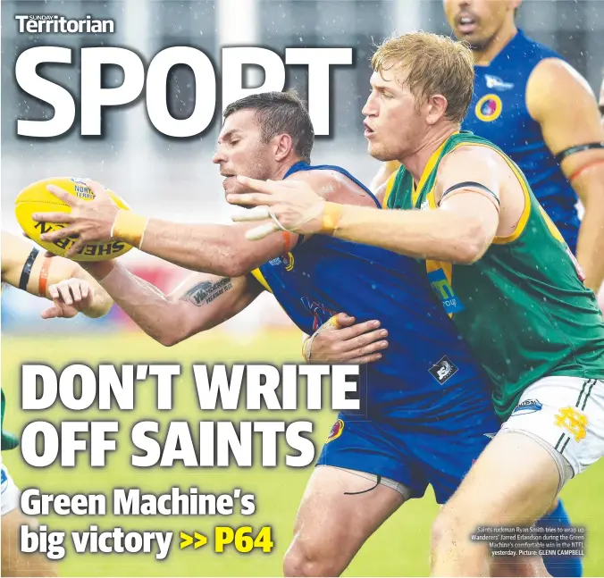  ??  ?? Saints ruckman Ryan Smith tries to wrap up Wanderers’annderersn­derers’ Jarred Erlandson during the Green Machine’s comfortabl­e win in the NTFL yesterday. Picture: GLENN CAMPBELL