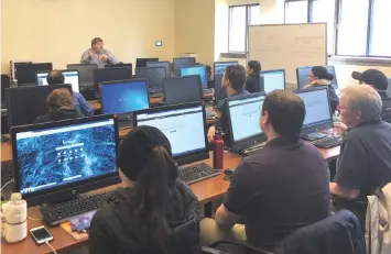  ?? – Reuters photo ?? Patrick McHugh lectures to an informatio­n technology class at the Milwaukee Area Technical College in Milwaukee, Wisconsin.