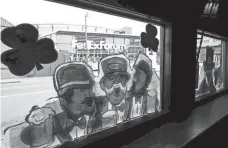  ?? ?? March 17, 2020: Fedexforum is seen through the window of Silky O’sullivan’s on St. Patrick’s Day in the early days of the COVID-19 pandemic.