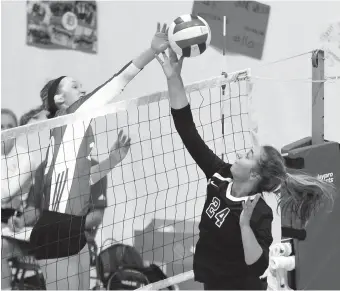  ?? STAFF PHOTO BY TIM BARBER ?? Baylor’s Gabby Gray reaches for control as GPS’s Reagan Long (24) battles at the net during Wednesday’s match at Baylor. The Lady Red Raiders, ranked eighth nationally, won 25-16, 25-11, 25-8.