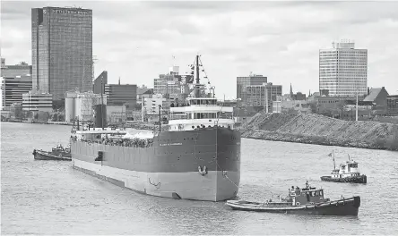  ?? JIM HOFFMAN ?? On Oct. 27, 2012, the historic Great Lakes freighter S.S. Col. James M. Schoonmake­r is tugged on the Maumee River past the Toledo skyline to its new mooring at the National Museum of the Great Lakes.