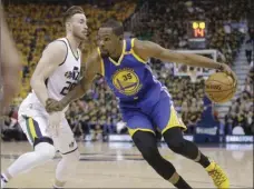  ??  ?? Utah Jazz forward Gordon Hayward (left) guards against Golden State Warriors forward Kevin Durant who drives in the first half during Game 3 of the NBA basketball second-round playoff series Saturday in Salt Lake City. AP PHOTO