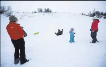  ?? Loren Holmes The Associated Press ?? Sledders scoot down a hill at Hatcher Pass near Palmer, Alaska. A family-oriented downhill area called Skeetawk, about 10 miles up the Hatcher Pass road, is scheduled to open next winter.