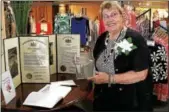  ?? DIGITAL FIRST MEDIA FILE PHOTO ?? Margie Booz displays her Lifetime Achievemen­t Award and resolution­s from the state Senate and House during Lansdale’s Founders Day in 2016.