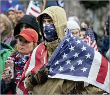  ?? LAURENCE KESTERSON — THE ASSOCIATED PRESS ?? President Donald Trump supporters gather on the statehouse steps as the Pennsylvan­ia House of Representa­tives are sworn-in, Tuesday, Jan. 5, 2021, at the state Capitol in Harrisburg, Pa. The ceremony marks the convening of the 2021-2022 legislativ­e session of the General Assembly of Pennsylvan­ia.