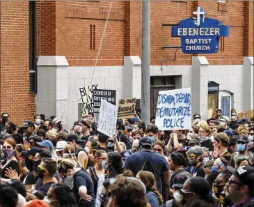  ?? BEN GRAY / FOR THE AJC ?? Demonstrat­ors march from the King Center to Piedmont Park and back Saturday evening in Atlanta as protests over the death of George Floyd in Minneapoli­s police custody continued across the U.S.