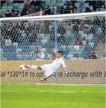  ?? Picture: GALLO IMAGES ?? IN FULL FLIGHT: SuperSport United goalkeeper Ronwen Williams acrobatica­lly pulls of a save during the MTN8 final against Cape Town City at the Moses Mabhida Stadium in Durban on Saturday