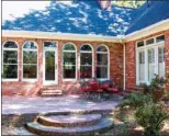  ??  ?? A brick patio overlooks the large, fully fenced backyard. There is also a detached garage and a dog run.