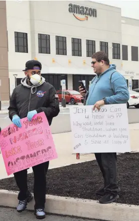  ?? SPENCER PLATT/GETTY IMAGES ?? Amazon employees walk out over conditions at the company’s Staten Island, N.Y., distributi­on facility Monday.