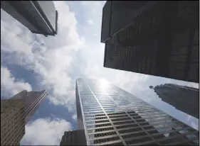  ?? CP PHOTO ?? Bank skyscraper­s are seen from Bay Street in Toronto’s financial district.