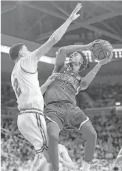  ?? Mark J. Terrill / Associated Press ?? Arizona guard Kobi Simmons, right, goes up for two of his 20 points as UCLA guard Lonzo Ball defends in the first half of Saturday’s game at Los Angeles.